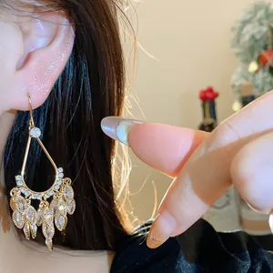 Close-up of 18k gold plated water drop tassel earrings with shimmering zircons