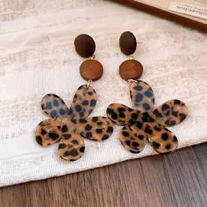 Close-up of vintage leopard print flower earrings with wooden accents in Maillard style