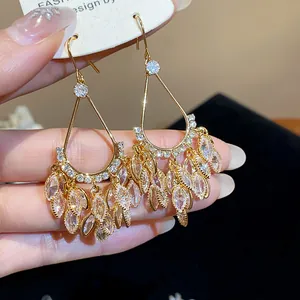 Detailed view of 18k gold plated drop earrings with sparkling zircon fringe tassels.