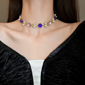 Close-up detail of a vintage geometric pearl choker necklace worn by a model