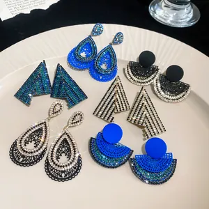 Detailed view of assorted geometric rhinestone earrings with elegant engraved patterns