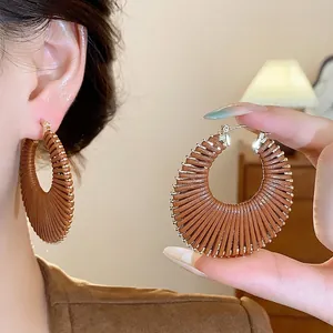 Large brown leather wrapped hoop earrings for women in a stylish hollow design