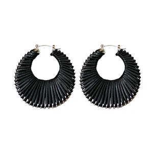 Handcrafted black woven round hoop earrings featuring a stylish hollow fan design
