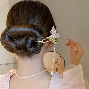 Detailed view of an elegant butterfly hairpin with pearl tassels in a Chinese bun