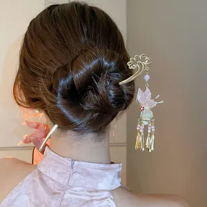 Detailed view of a Chinese style butterfly hair stick with elegant pearl tassels on a bun.