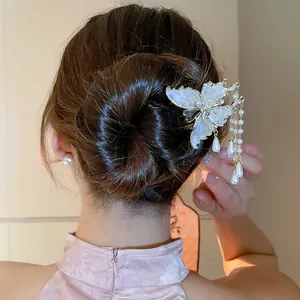 Close-up detail of an elegant butterfly pearl tassel hairpin worn in a stylish bun hairstyle