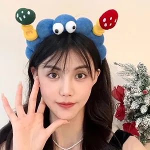 Creative cartoon plush headband with cute mushroom and eye design worn by a woman