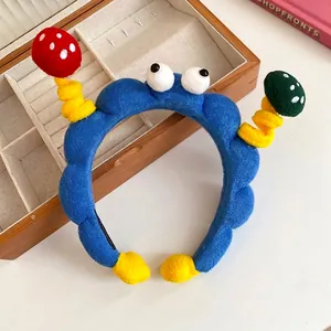 Cute blue plush cartoon headband with funny mushroom antennae and large googly eyes
