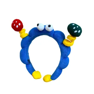Fun plush blue headband with cartoon eyes and colorful mushroom antennas hair accessory