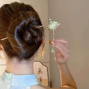 Elegant Chinese style butterfly hair stick with pearl tassel detail worn in a stylish bun