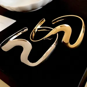 Minimalist wavy metal open bangle in gold and silver finishes