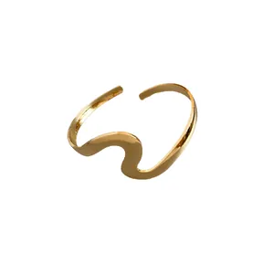 Minimalist wavy metal open bracelet with a polished gold finish and twisted design