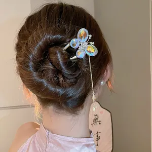 Detailed view of a New Chinese style butterfly hair pin with tassels on a bun hairstyle.