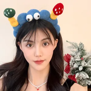 Macro view of a funny cartoon plush headband with googly eyes on an Asian model.