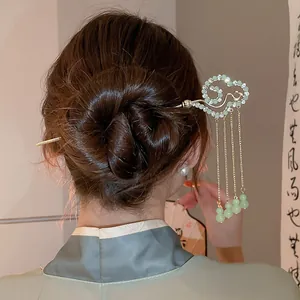 Close-up of new Chinese style hair stick with rhinestones and green bead tassels on hair