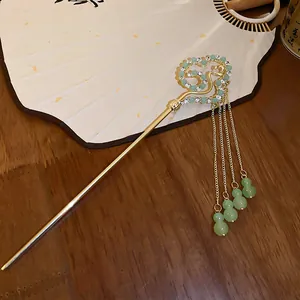 Traditional Chinese style gold hairpin with rhinestone heart and green bead tassels