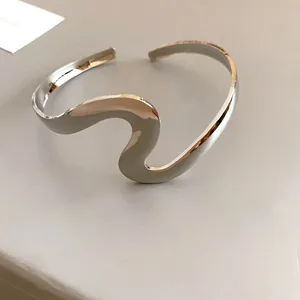 Minimalist silver wavy open bangle bracelet with a twisted metal design for women