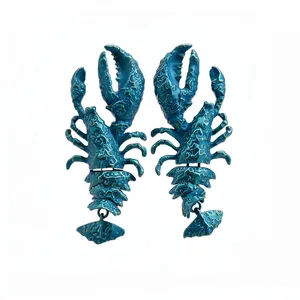 Unique exaggerated teal lobster-shaped drop earrings with a textured metallic paint finish