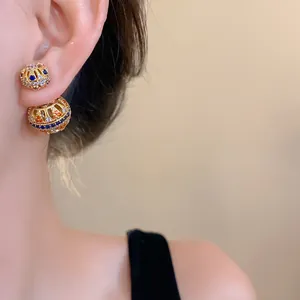 Detailaufnahme von vergoldeten 18k Vintage-Kugelohrringen mit bunten Zirkonia-Steinen