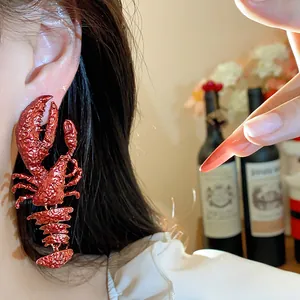 Detailed close-up of a stylish oversized red textured lobster earring being worn