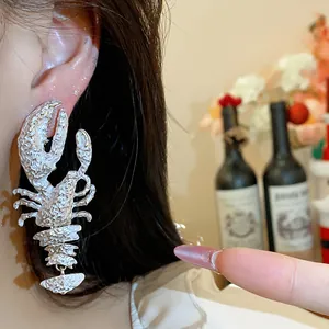 Detail shot of a large silver lobster earring with unique textured finish for fashion