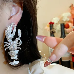 Trendy silver oversized lobster earrings with artistic textured finish for women.