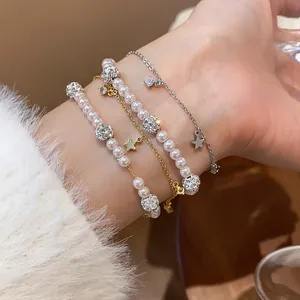 Close-up of elegant multi-layer bracelet with pearls, zircon balls and star charms