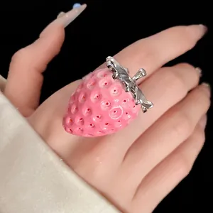 Sweet pink resin strawberry ring with silver leaves worn on hand for cute style