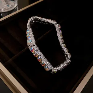 Macro view of geometric silver bracelet with iridescent square crystals in a box