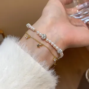 Elegant close-up view of a double-layer bracelet with pearls and gold star charms