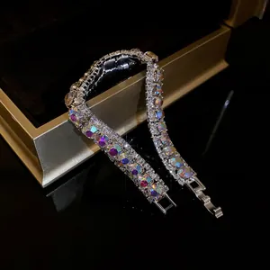 Close-up of iridescent square rhinestones on a silver geometric buckle bracelet