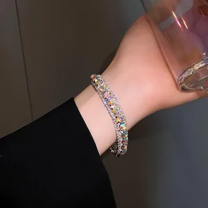 Detailed view of a silver geometric bracelet featuring iridescent square crystals