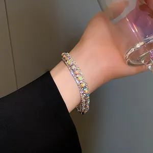 Close-up view of a sparkling rhinestone geometric buckle bracelet on a woman's wrist