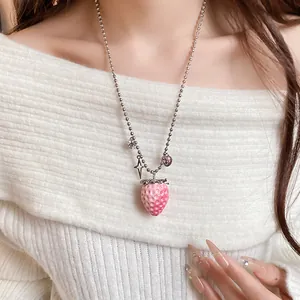 Close-up of a sweet resin strawberry pendant necklace on a stainless steel ball chain.
