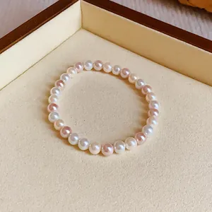 Elegant pearl elastic bracelet with mixed white and pink pearls on display tray
