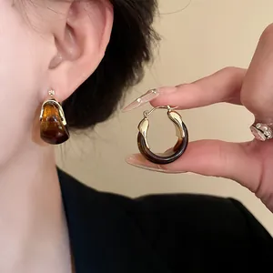 Vintage U-shaped amber smudge basket earrings for women showing close-up jewelry details