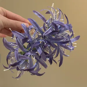 Detailed view of the purple fabric spider lily hair claw clip's intricate petals.