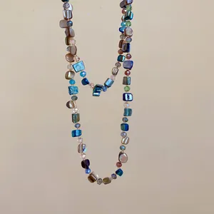Detail of colorful irregular crystal beaded necklace in bohemian vintage style.