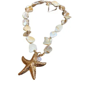 Elegant handmade vacation style necklace featuring a golden starfish and shell beads