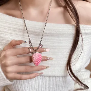 Detailed macro view of a sweet pink resin strawberry pendant necklace for women