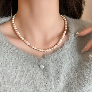 Elegant multi-colored pearl necklace close-up on model for a sweet and high-end look.