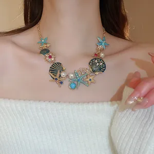 Detailed view of an ocean-themed necklace with gold starfish and pearl accents