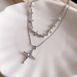 Exquisite silver double layered necklace featuring a four-pointed star pendant on a white shell plate