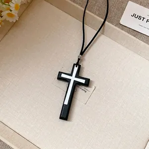 Retro minimalist black and white double cross pendant necklace on a leather cord