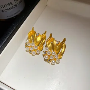 Detailansicht von Vintage-Ohrringen aus mattem Gold mit Perlen und Zirkonsteinen