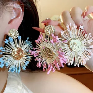 Handmade colorful raffia flower earrings with golden hammered metal center for summer vacation style