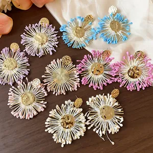 Detailed view of colorful handmade raffia flower earrings in various vibrant shades