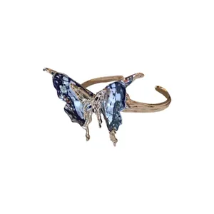 Elegant vintage style butterfly open cuff bracelet with detailed blue patterned wings