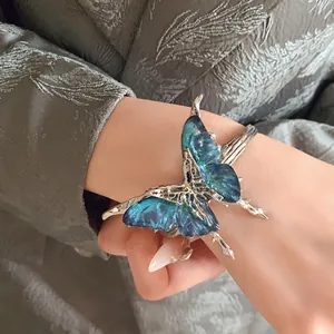 Close-up of vintage butterfly open cuff bracelet with blue gradient resin wings