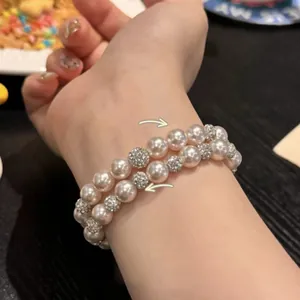 Elegant double-strand pearl bracelet with sparkling rhinestone spacers for women's wear